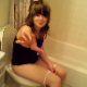Some annoying guy video-records his girlfriend as she tries to take a shit while sitting on a toilet. She loses her urge and goes to another bathroom. No pooping seen.
